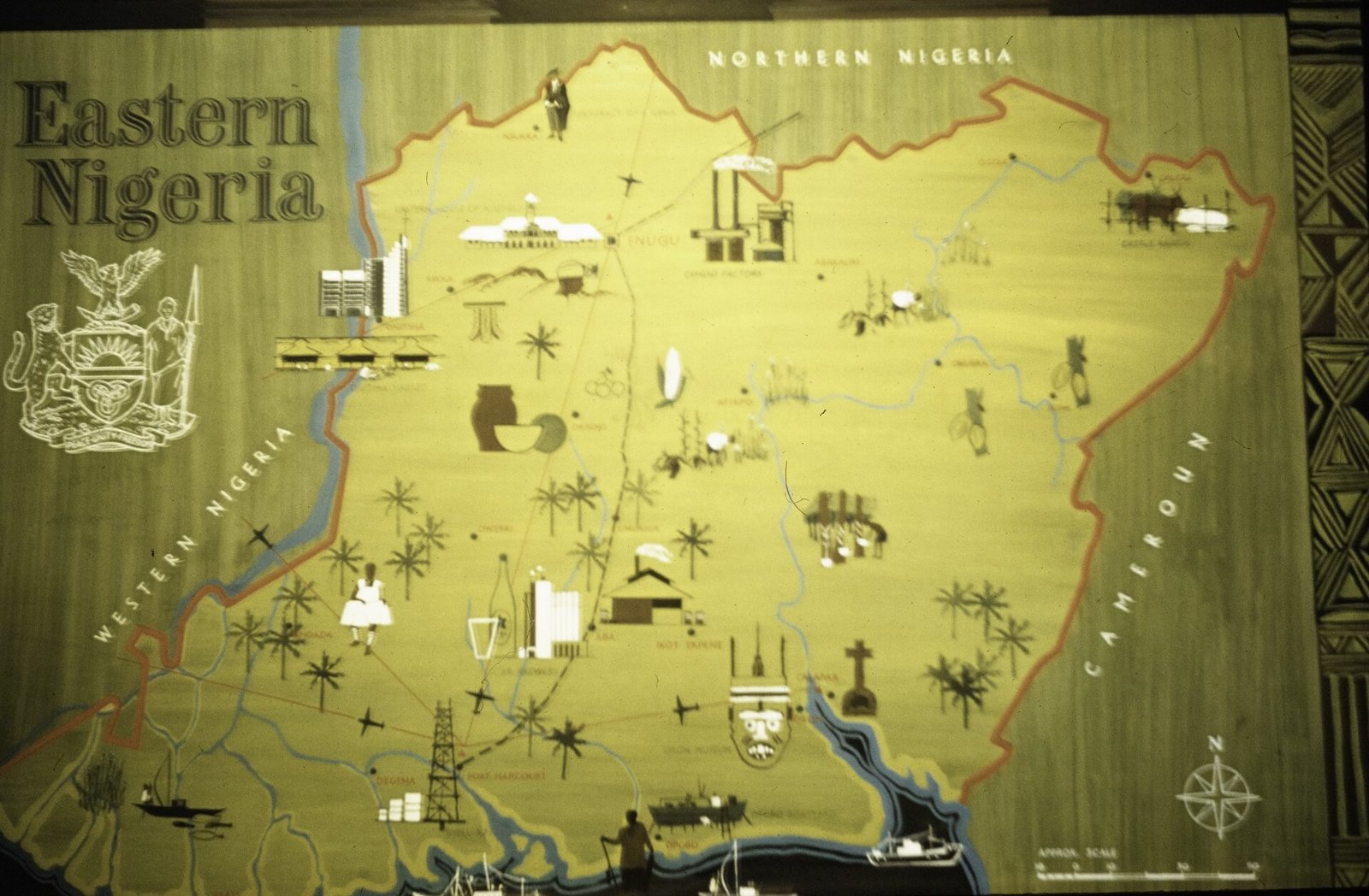A painted pictorial map headed Eastern Nigeria, with the region's coat of arms, its border drawn in red, Northern Nigeria and Western Nigeria labelled beyond it, Cameroun to the east, and small pictures of factories, palm trees, an oil derrick and aircraft.