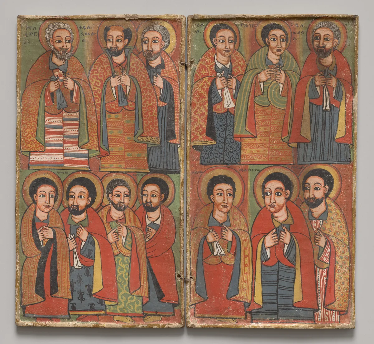 Two hinged painted panels with rows of haloed, bearded men in red and green robes.