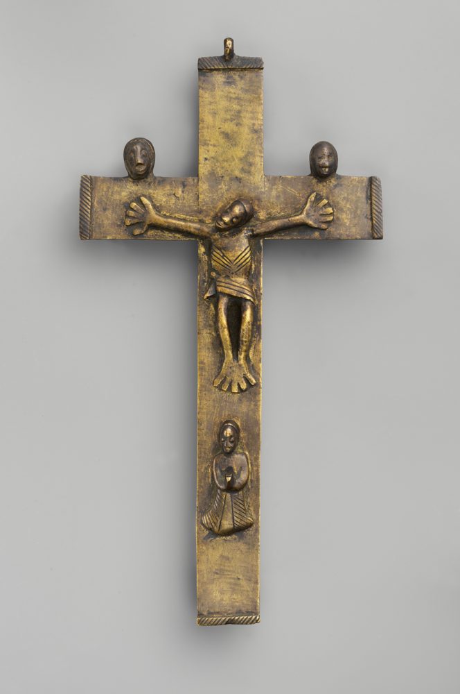 A brass crucifix with a figure of Christ on a cross with flared ends.