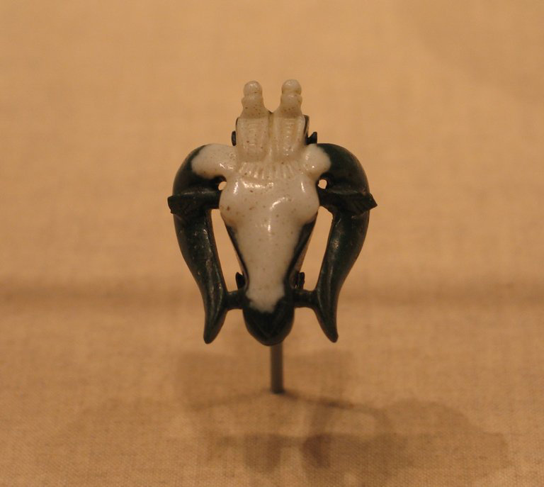A small jasper amulet carved as the head of a ram.
