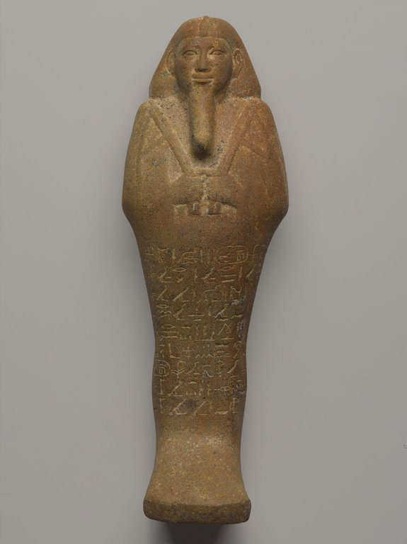 A tall ankerite funerary figurine of King Taharqa.